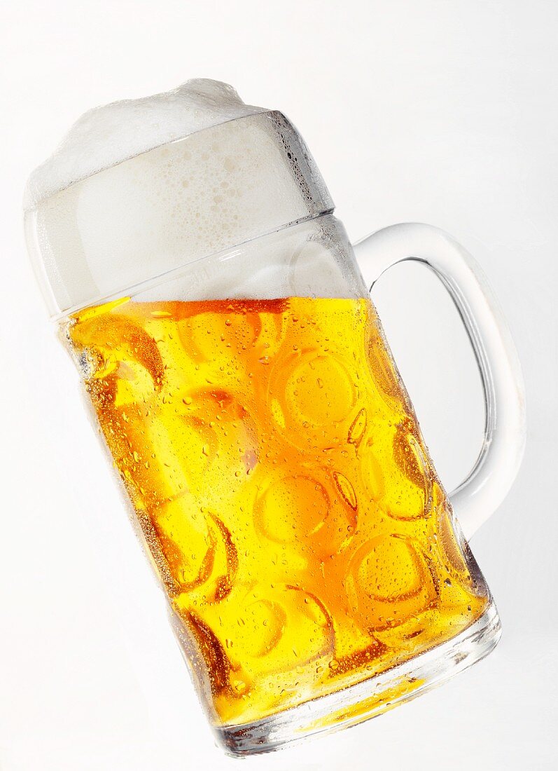 Light beer with head in glass tankard