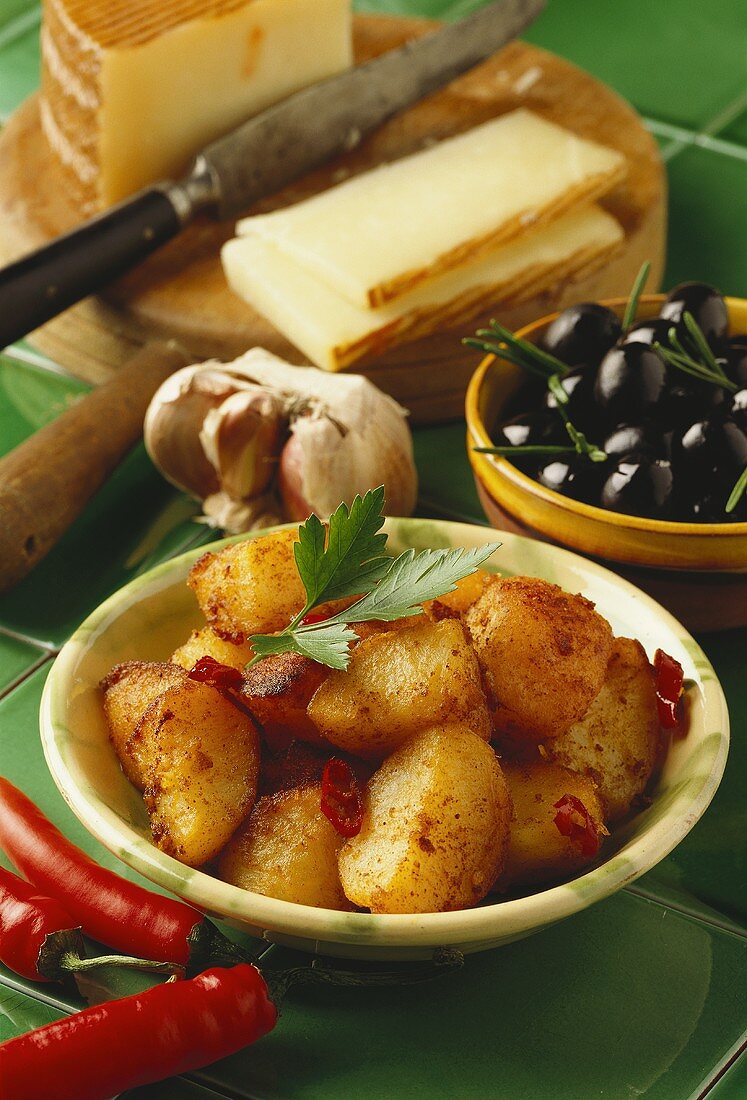 Fried potatoes with chili; olives, cheese