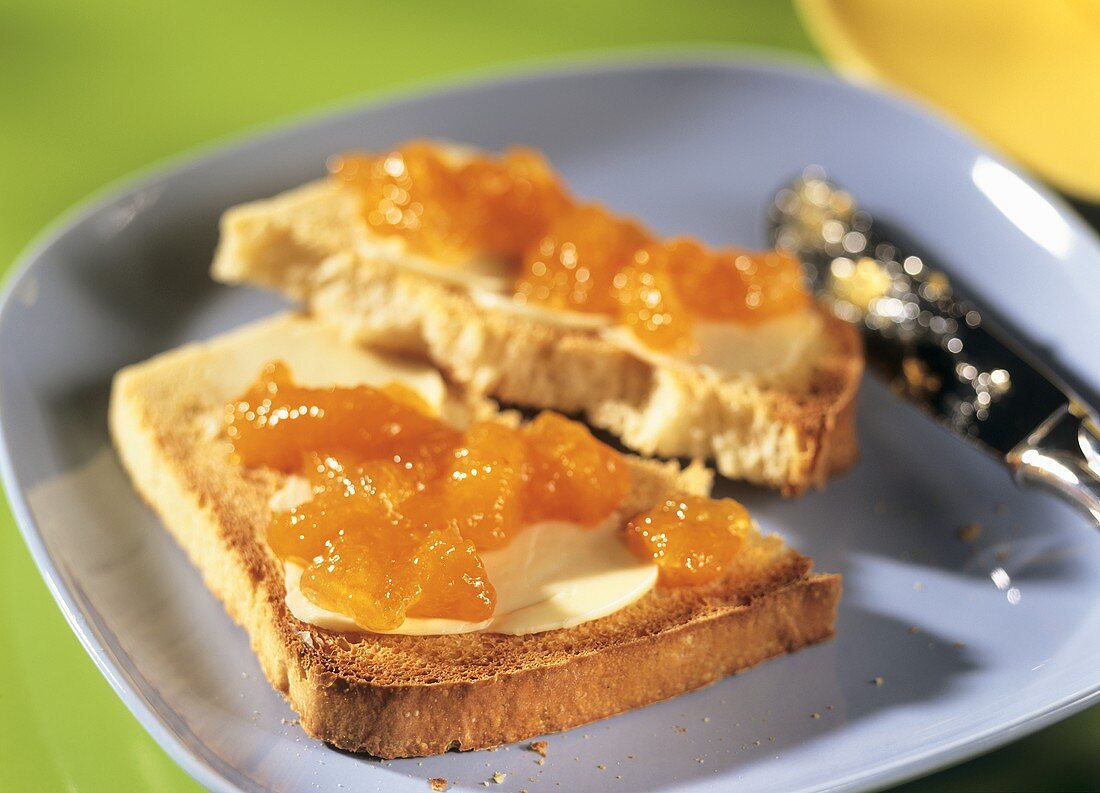 White sandwich bread with butter and apricot jam