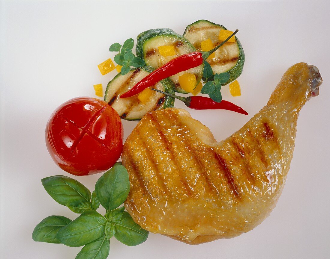 Barbecued chicken leg with vegetables and herbs