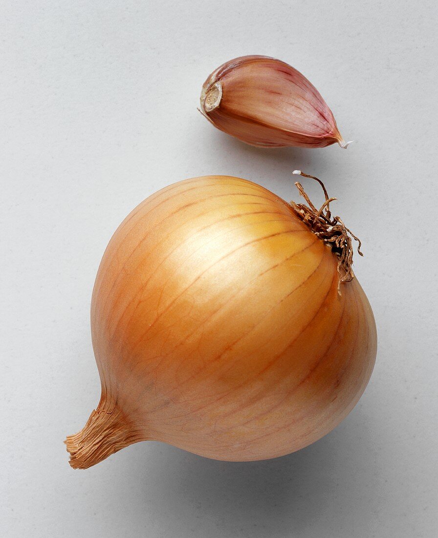 An onion and cloves of garlic