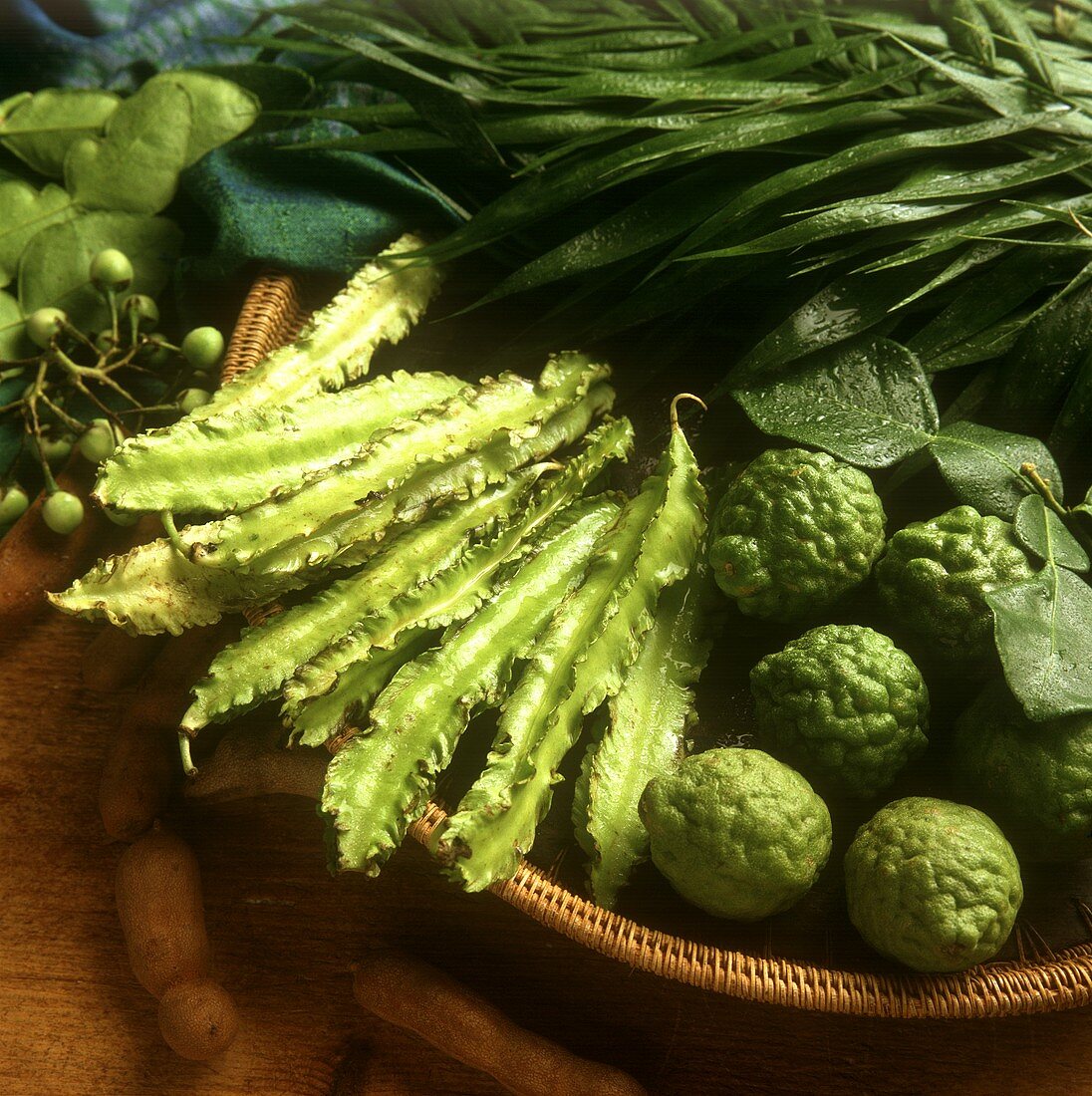 Asparagus peas and kafir limes in a basket