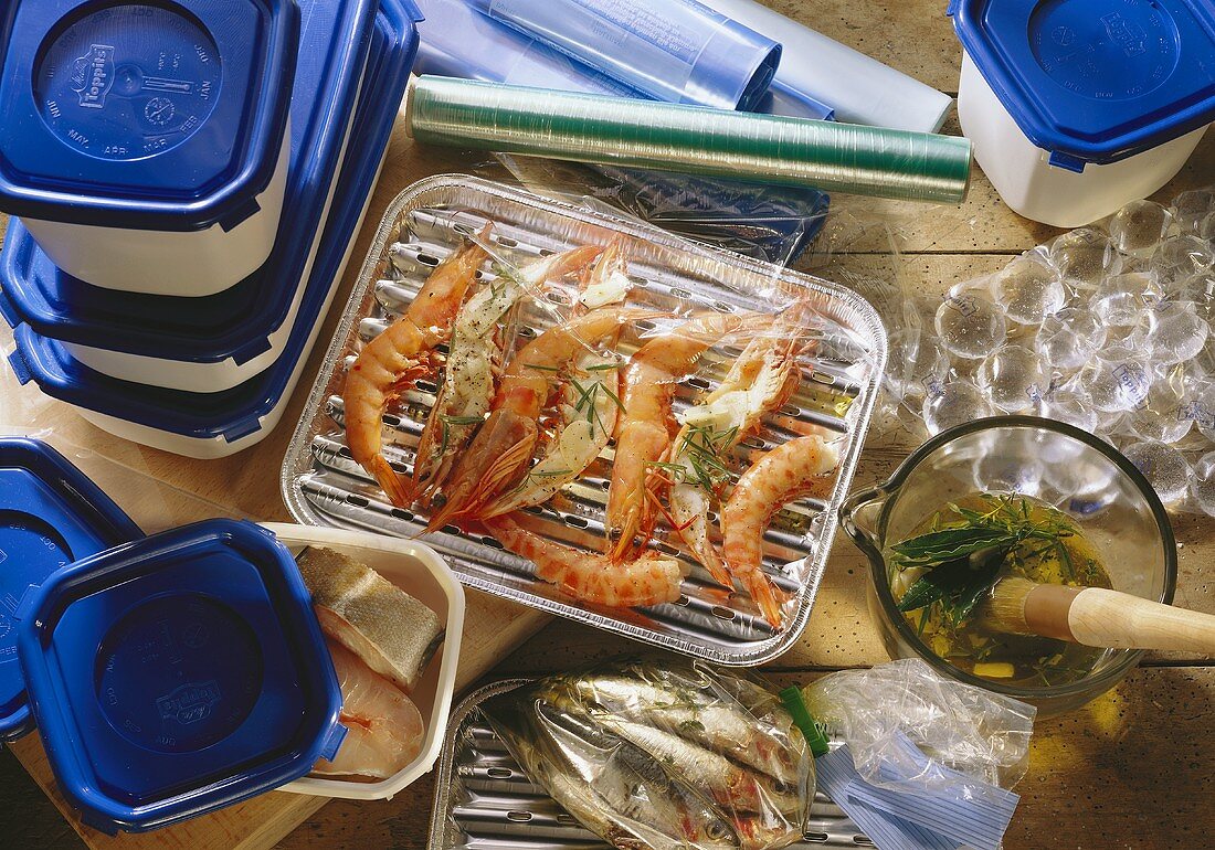 Shrimps & fish with food wrap, grill pan & plastic containers