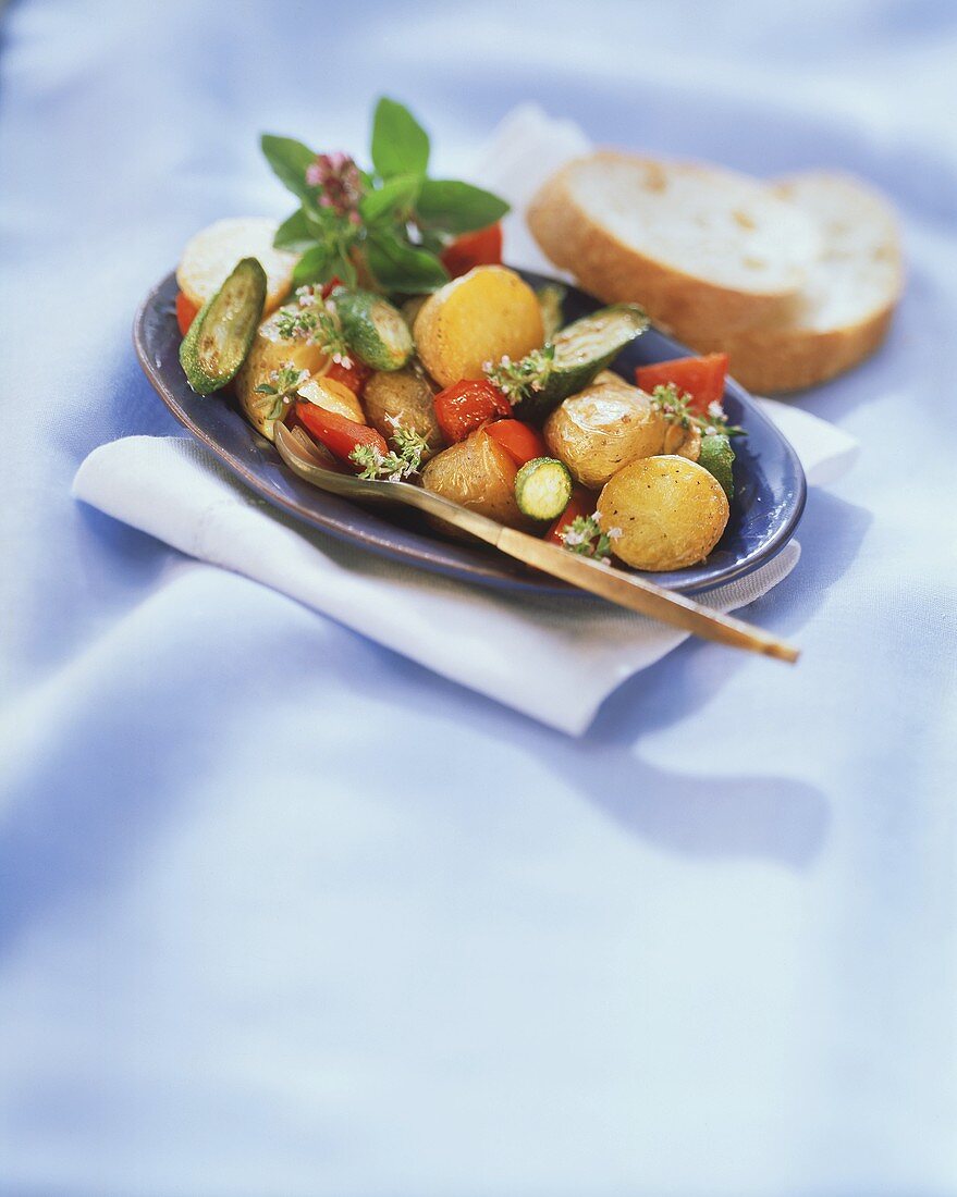 Oven-baked vegetables with fresh herbs & baguette slices