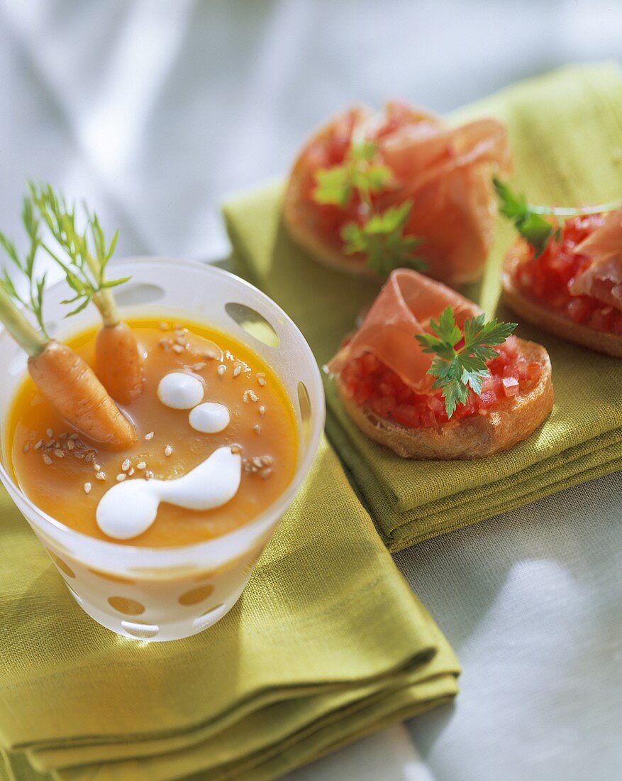 Carrot soup with sesame; crostini with tomato and ham