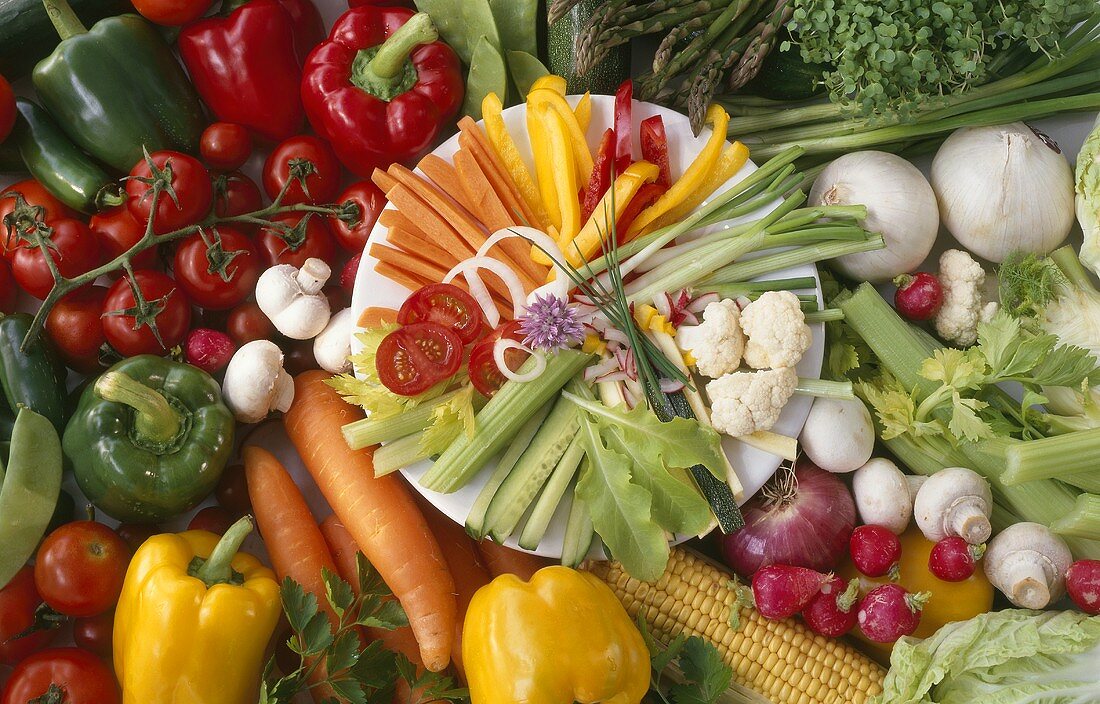 Plate of raw vegetables on various fresh vegetables