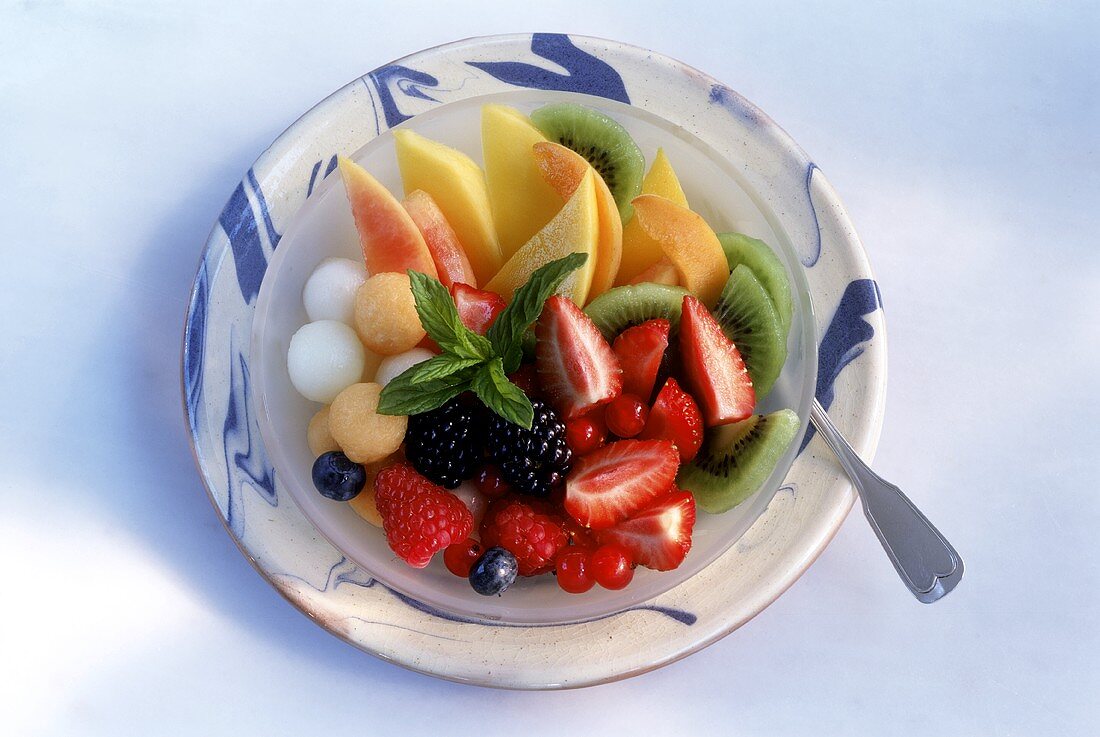 Fruit salad with mint leaf on plate