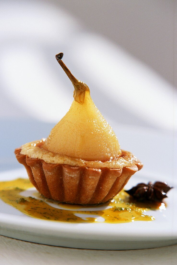 Tartlet with poached pear and caramel sauce
