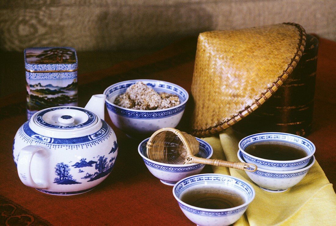 Tee in chinesischen Schälchen mit Teekanne, Teesieb etc.