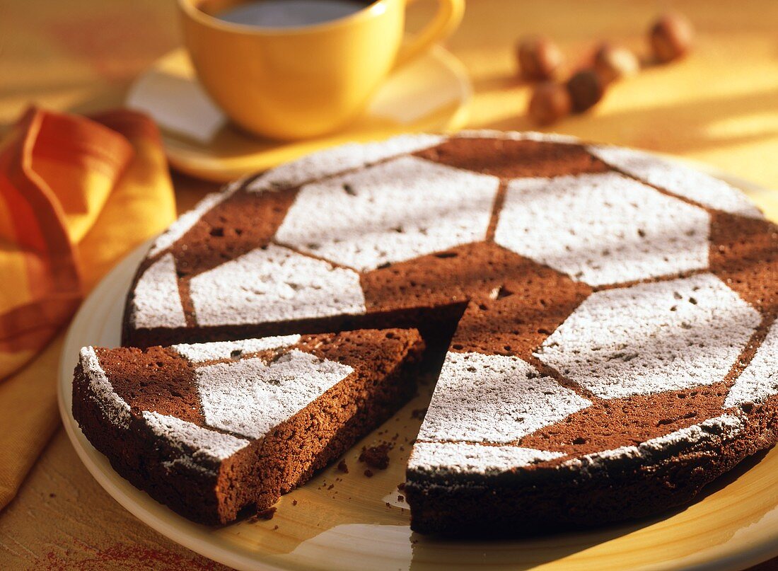 Football cake, a piece cut, with icing sugar decoration