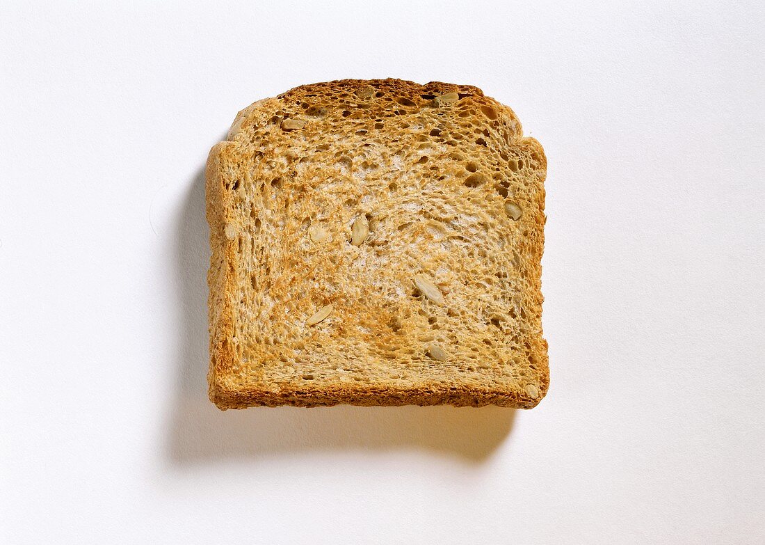 A slice of sunflower bread toast on white background