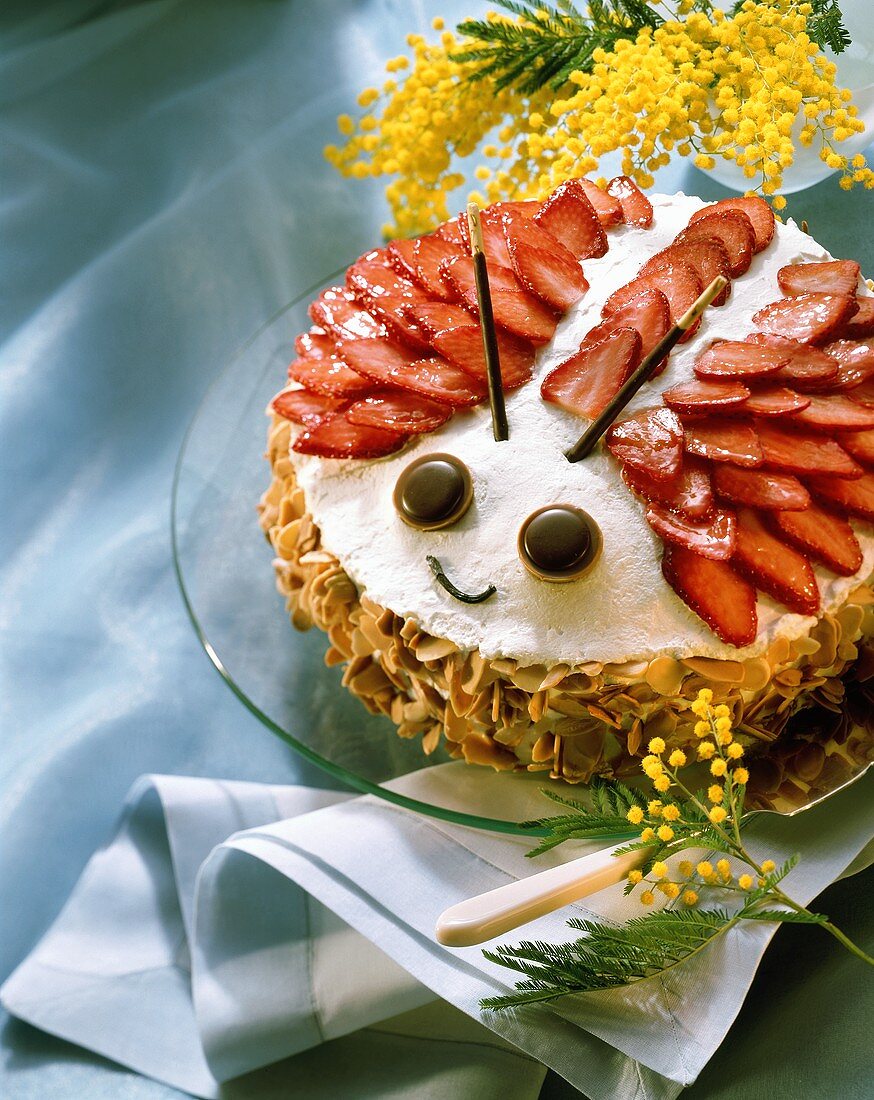 Strawberry marzipan cake, decorated as beetle, on plate