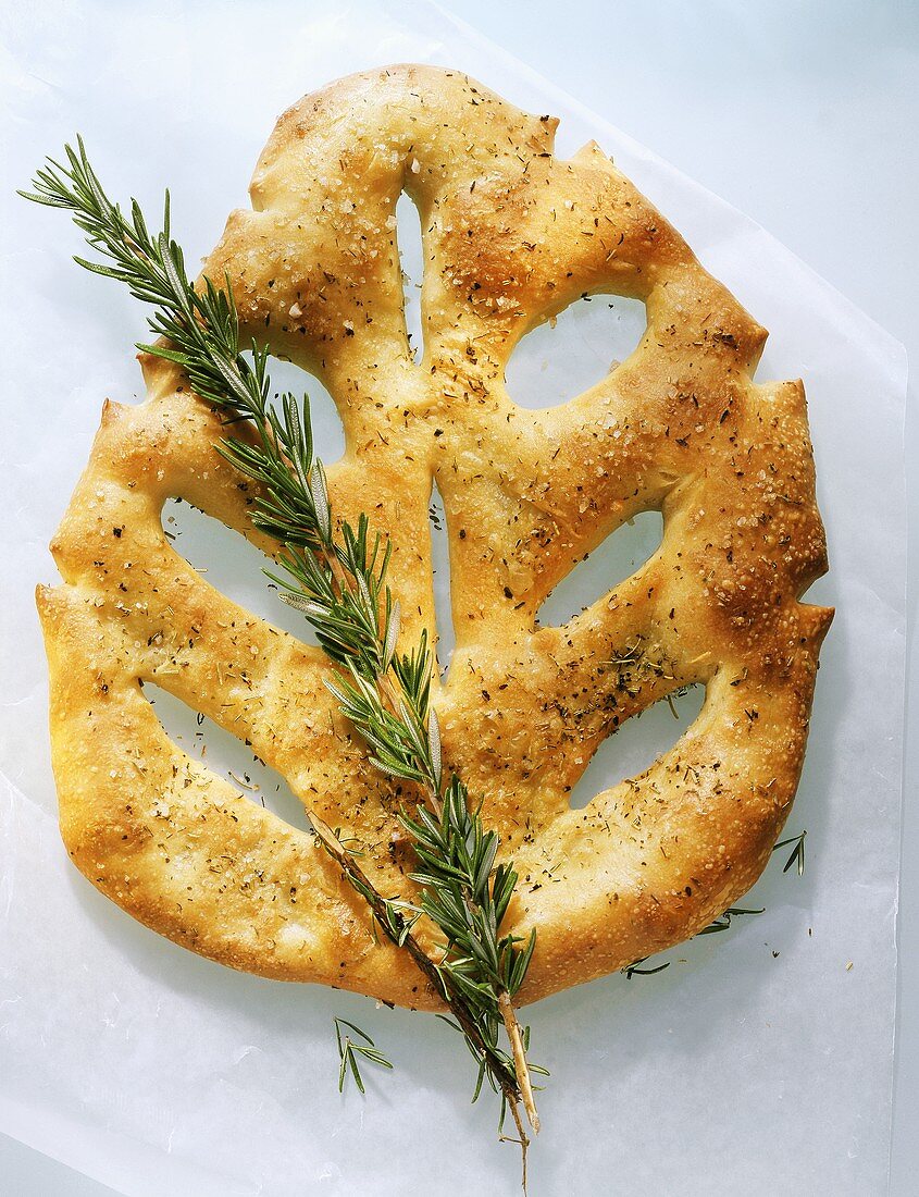 Flat bread in leaf shape with sprig of rosemary