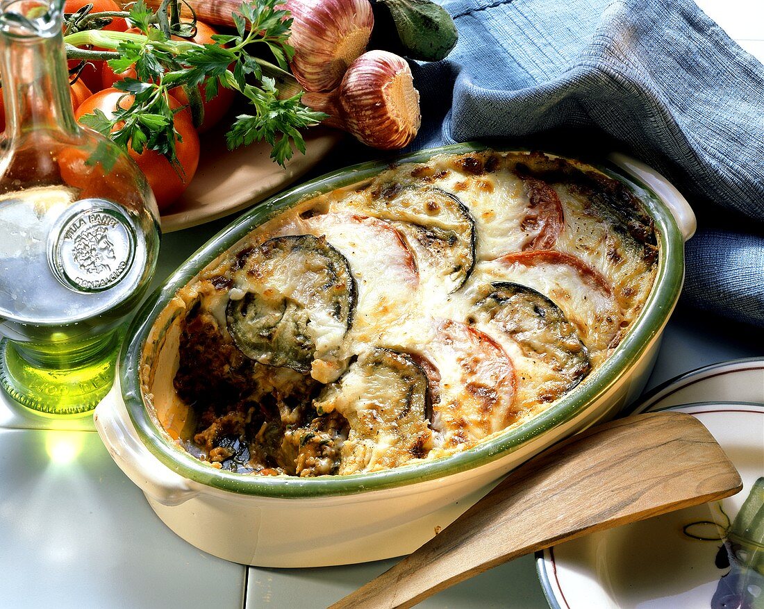 Moussaka in a baking dish; olive oil, tomatoes, garlic