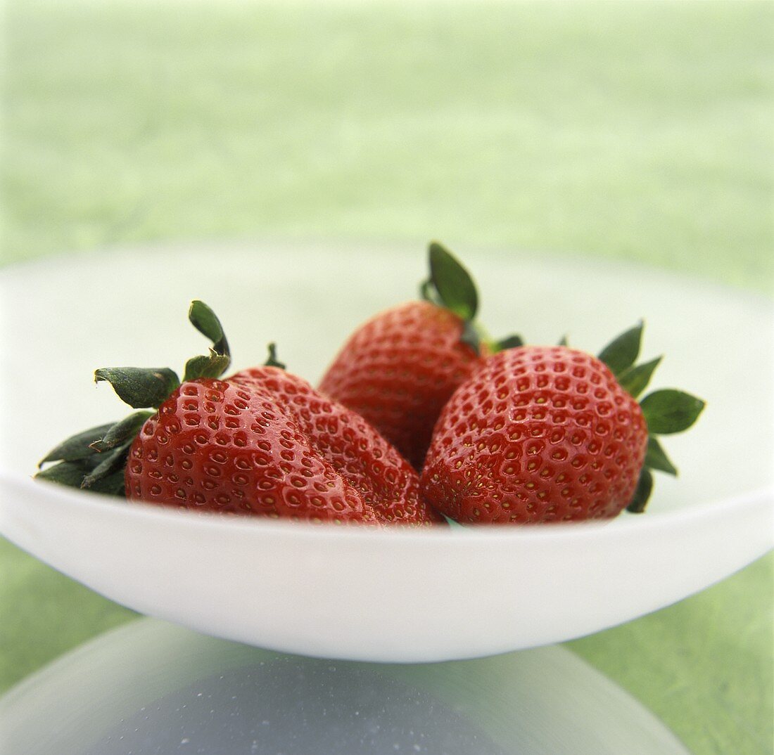 Three Strawberries in White Bowl