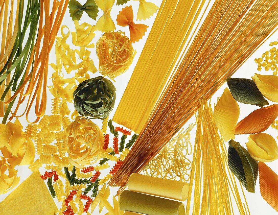 Various types of pasta on white background