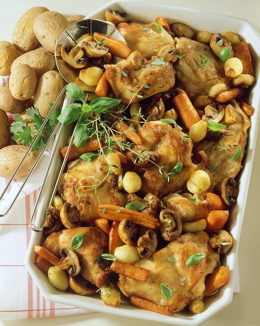 Braised rabbit with carrots and mushrooms in baking dish