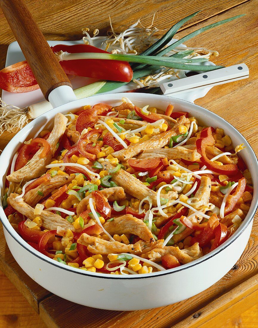 Finely chopped turkey with peppers, sweetcorn, sprouts in pan