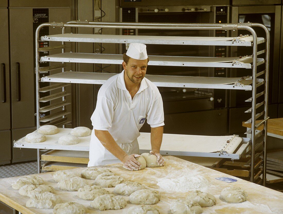 Baker kneading bread dough