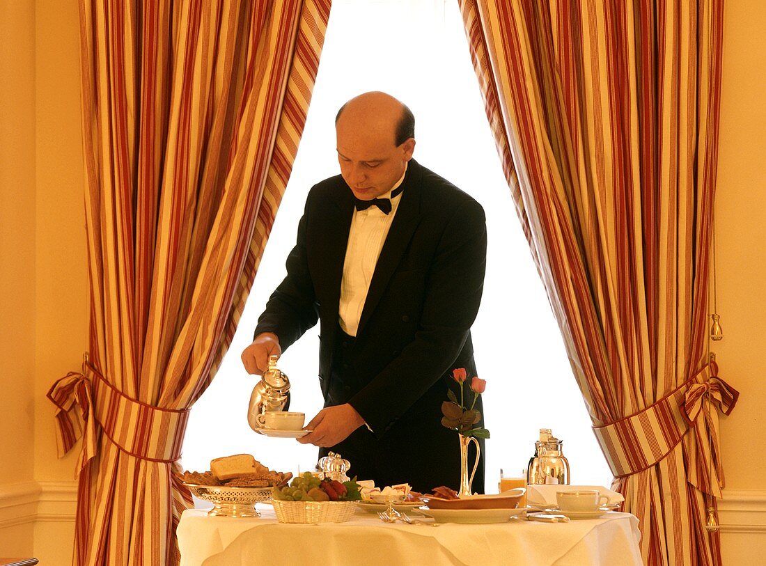 Waiter serving breakfast