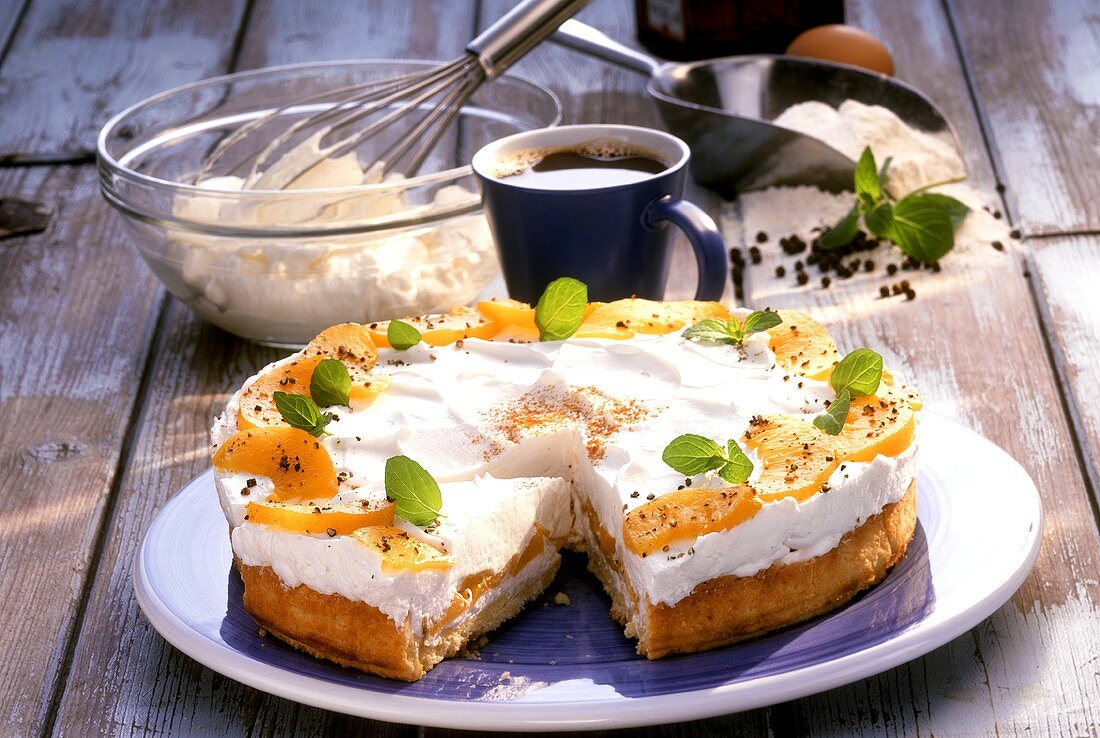 Peach and pepper gateau with cream and peppermint leaves