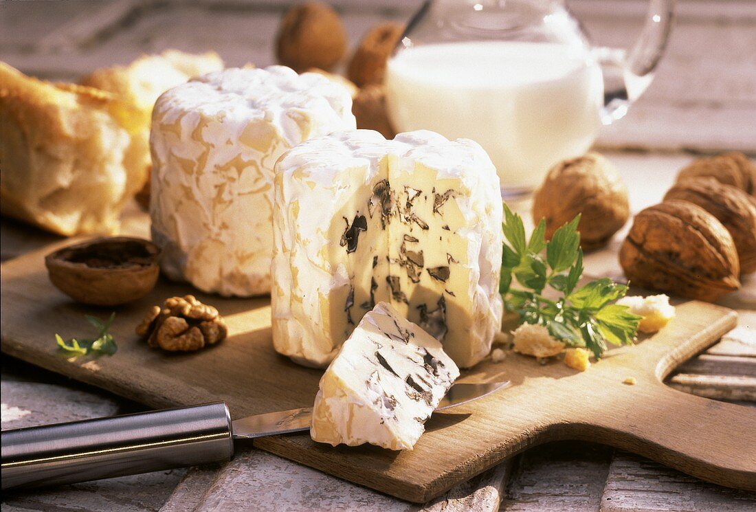Blue-veined cheese with walnuts on a chopping board