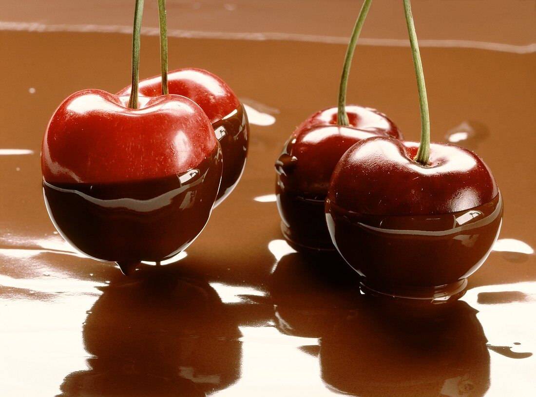 Fresh cherries, half with chocolate sauce