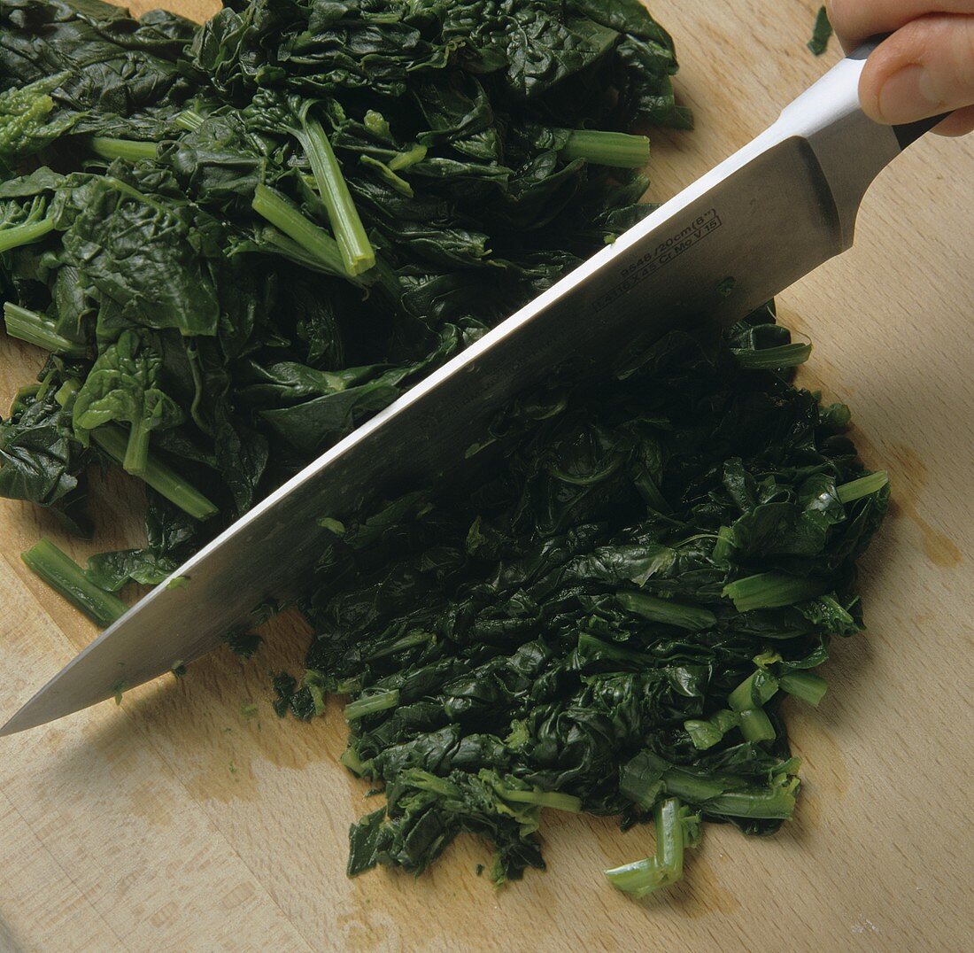 Chopping spinach with a knife