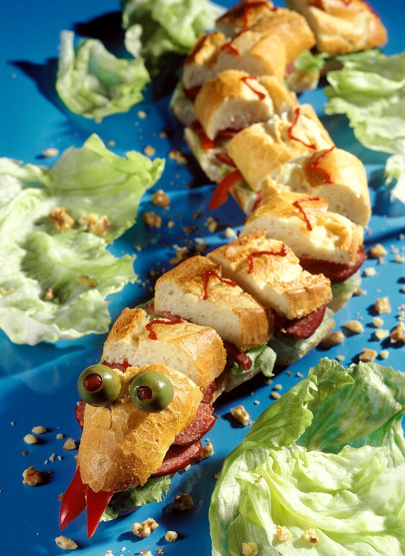Baguette snake with iceberg lettuce, nuts and sausage
