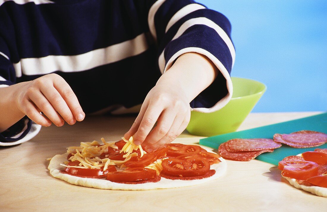 Sprinkling pizza with cheese