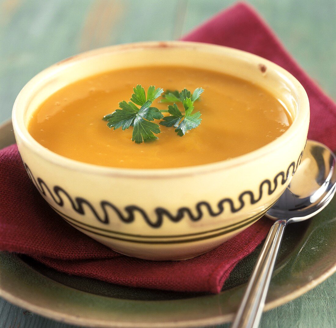 Carrot soup with coriander in a bowl