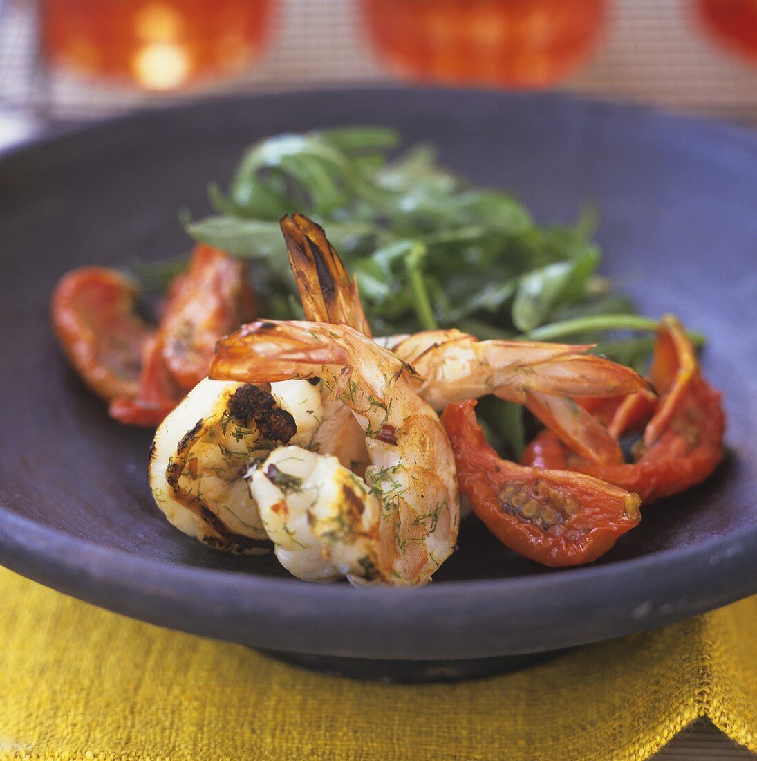 Grilled jumbo prawns with fried tomatoes on a plate