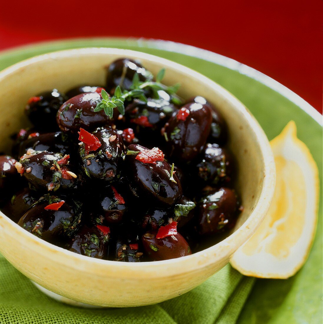 Bottled black olives in a yellow bowl
