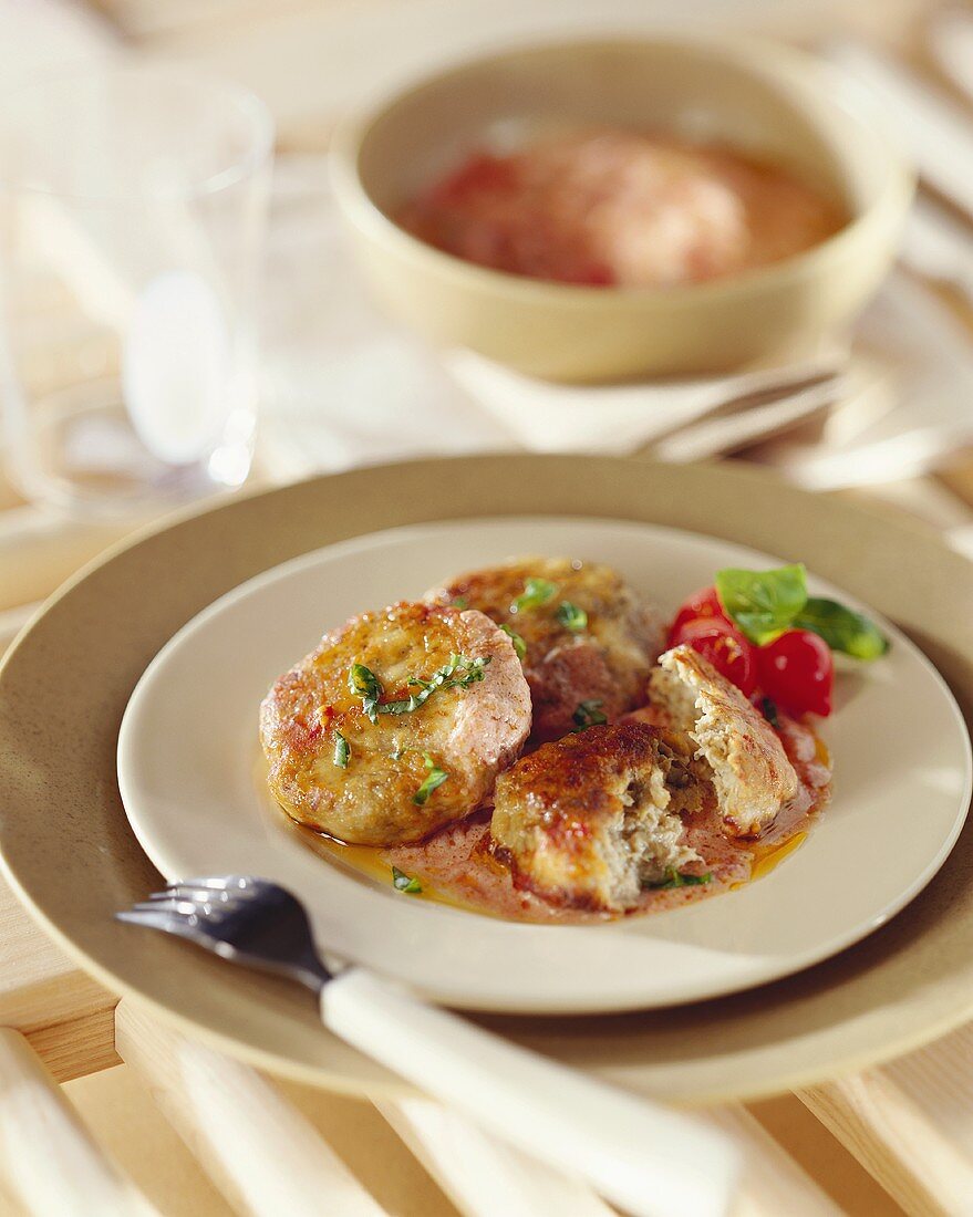 Rissoles with tomatoes on plate