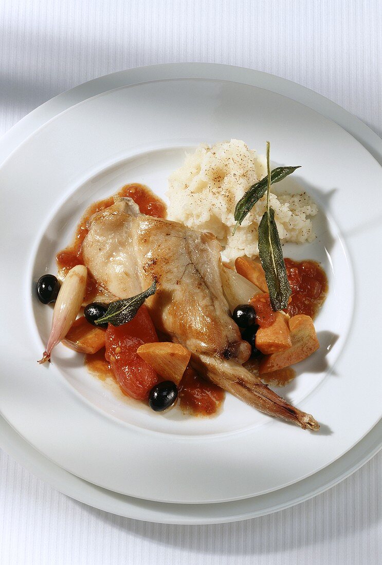 Rabbit with tomatoes, olives and mashed potato