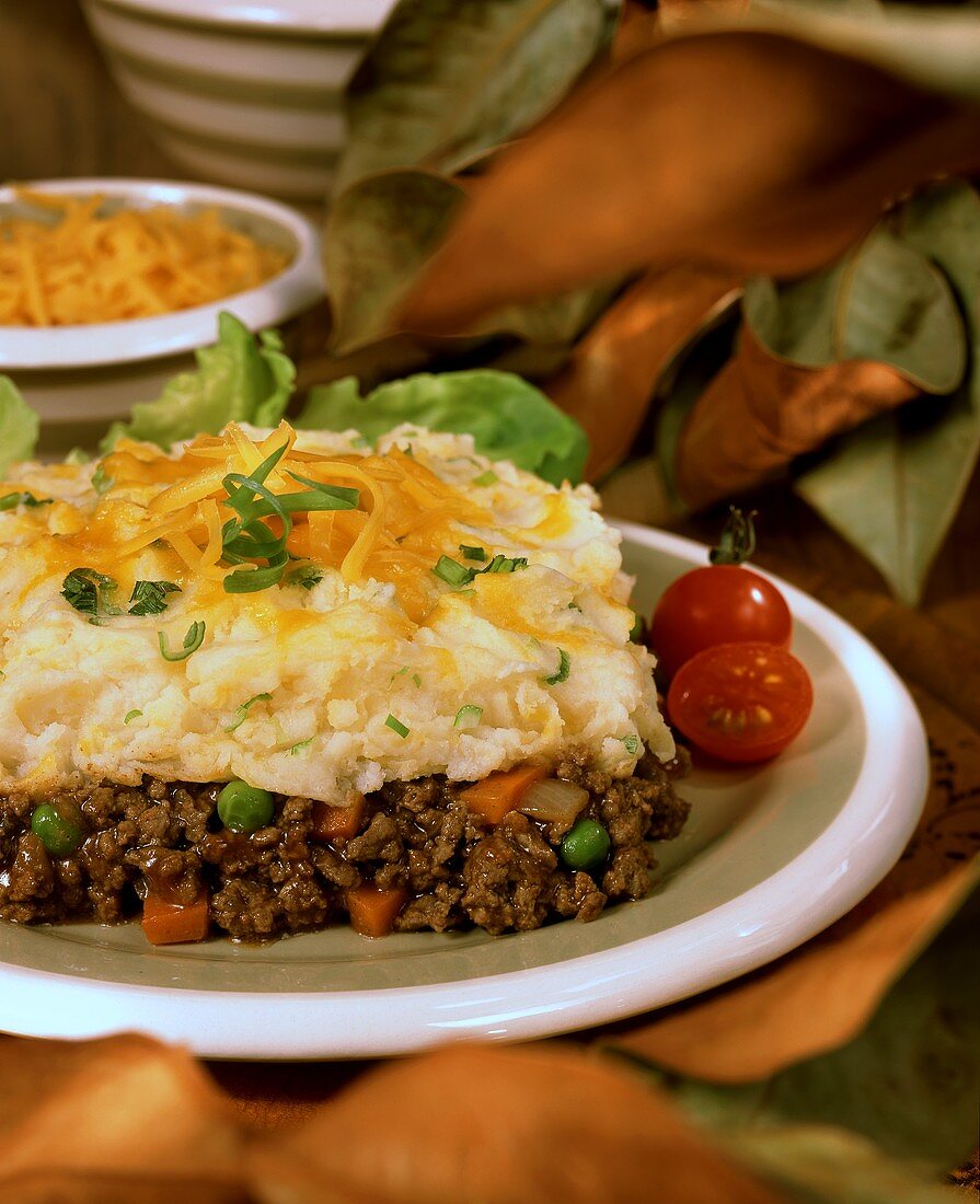 Mince and mashed potato pie with grated cheddar