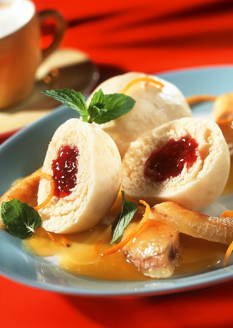 Cranberry dumplings with bananas in orange sauce