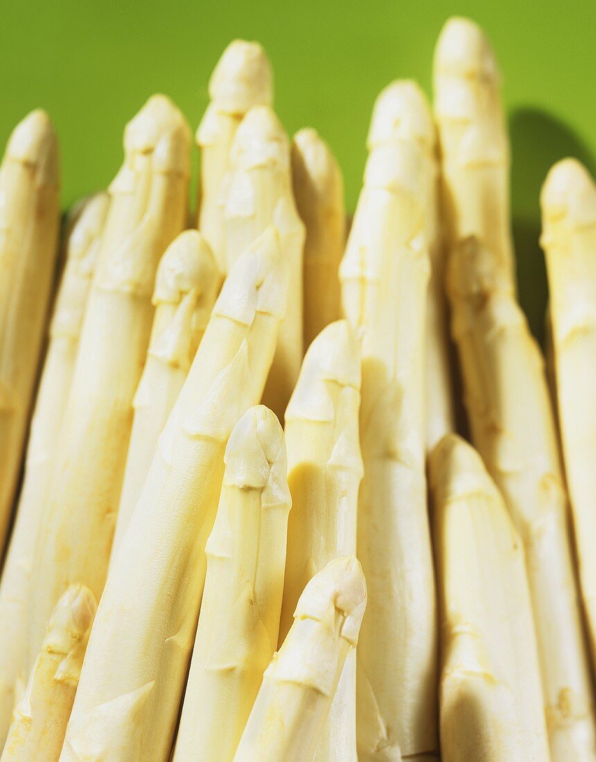 White asparagus on green background