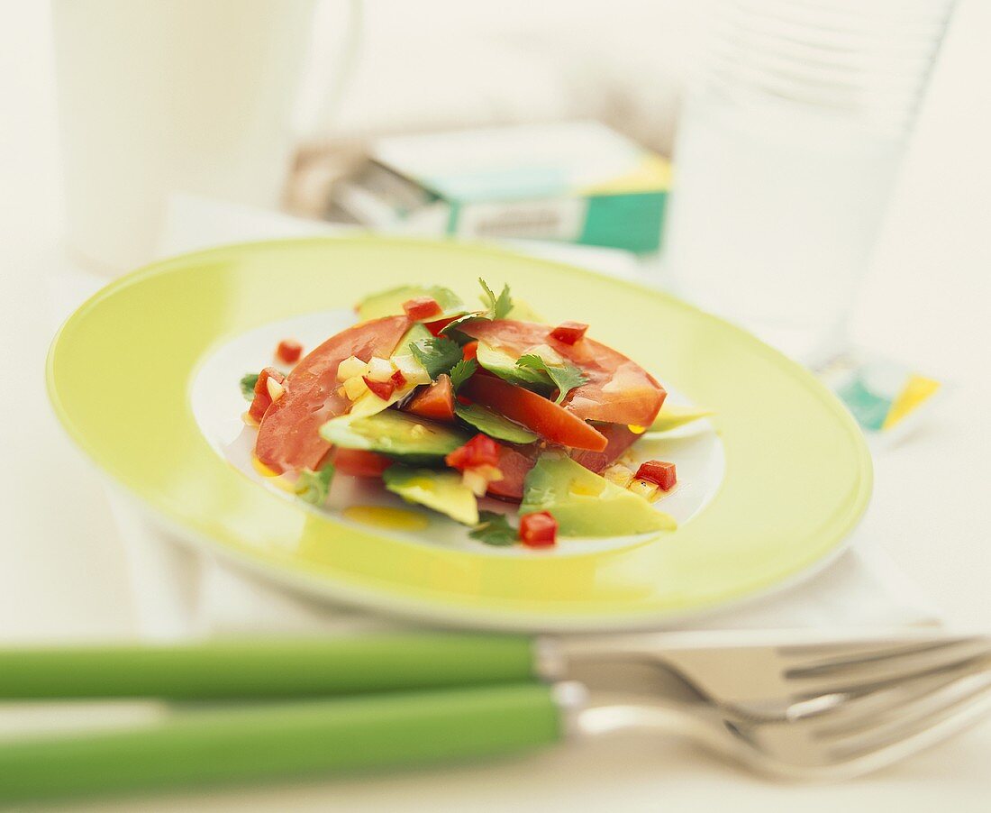 Tomato and avocado salad with pepper and chili sauce