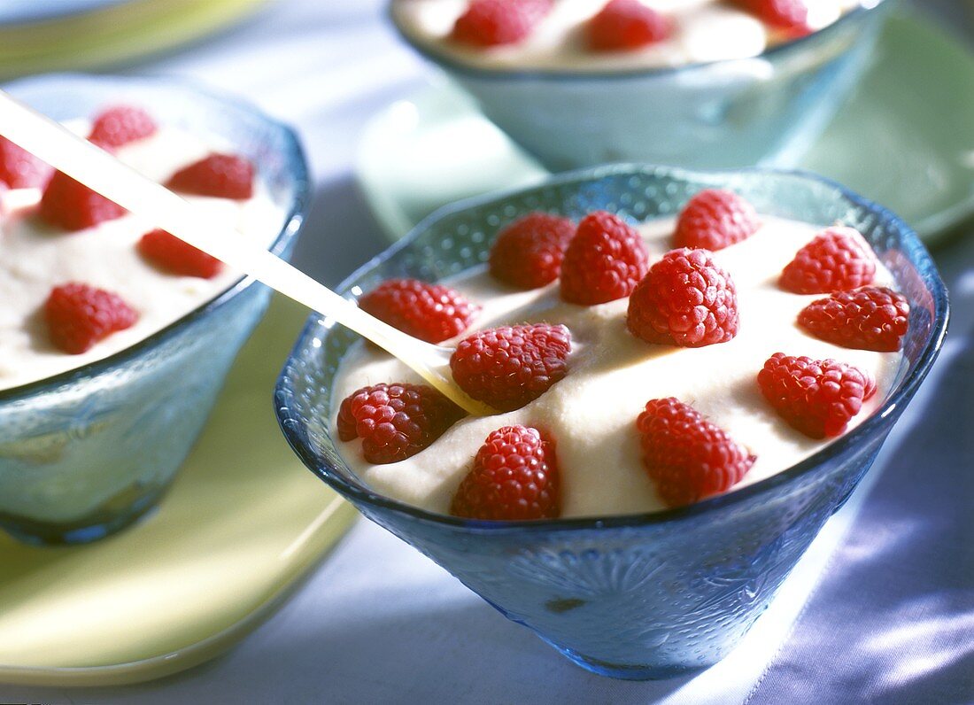 Mascarpone mousse with fresh raspberries in blue bowls