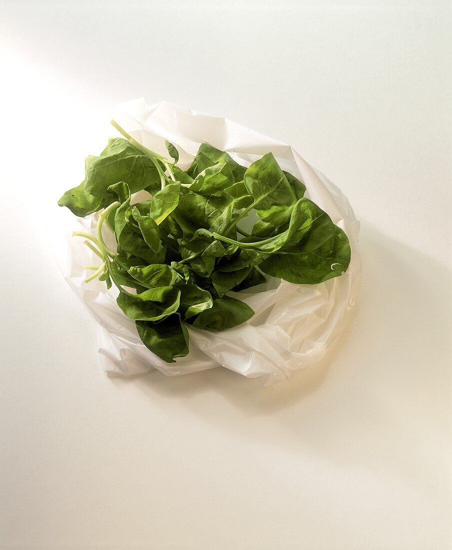 Fresh spinach leaves on a plastic bag