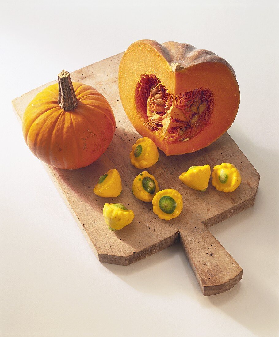 Various types of pumpkin and squash on chopping board