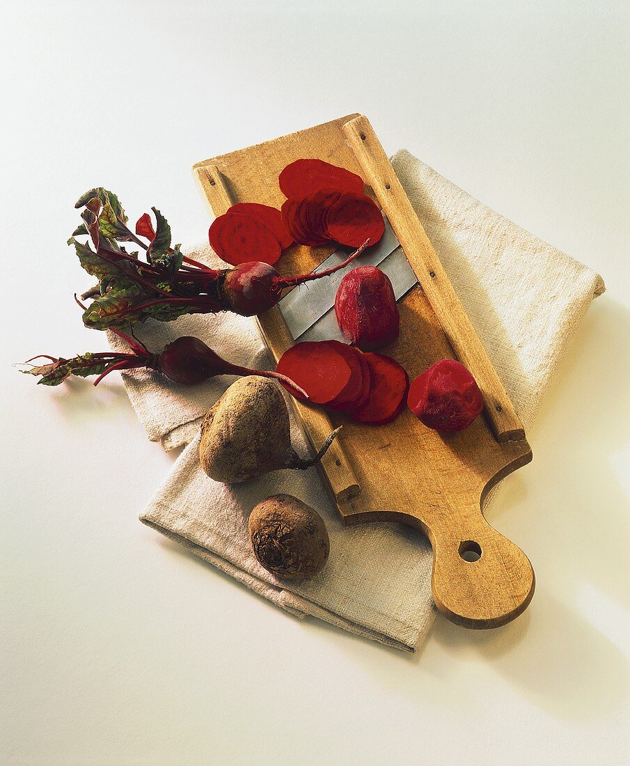 Beetroot with vegetable slicer on linen cloth