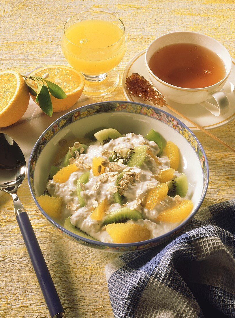 Kiwi fruit and orange muesli, tea and orange juice