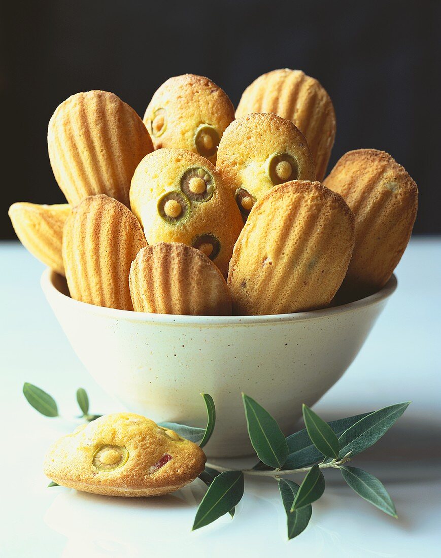 Madeleines with olives in a bowl