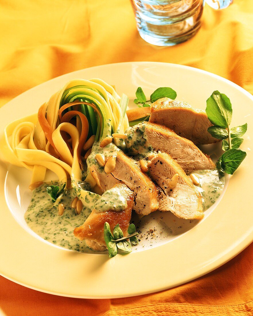Chicken breast with herb sauce and coloured ribbon pasta