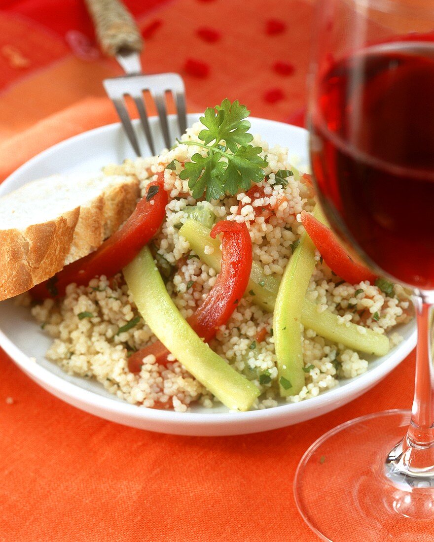 Couscous and vegetable salad with white bread and red wine