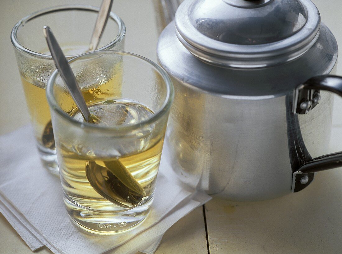 Greek mountain tea in glasses and metal teapot
