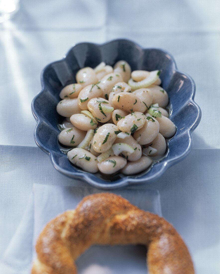 White bean salad in blue bowl; bread