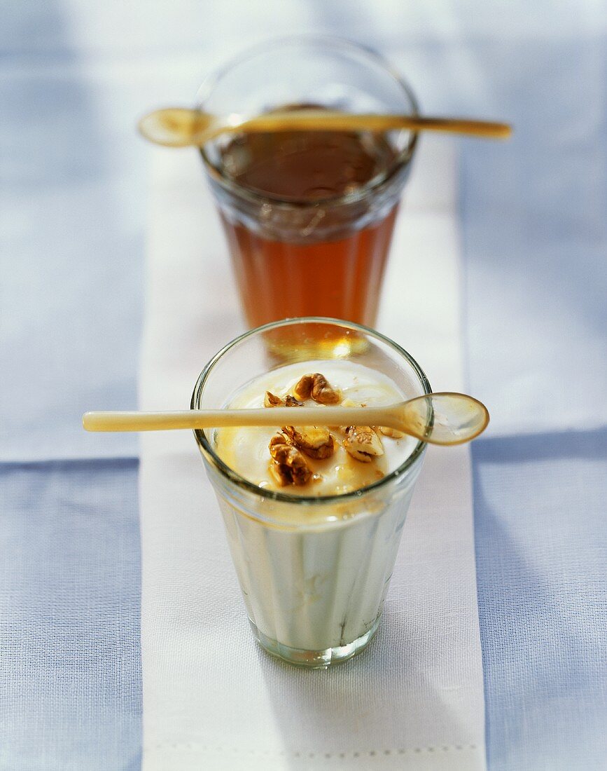 Yoghurt with honey and walnuts in glass